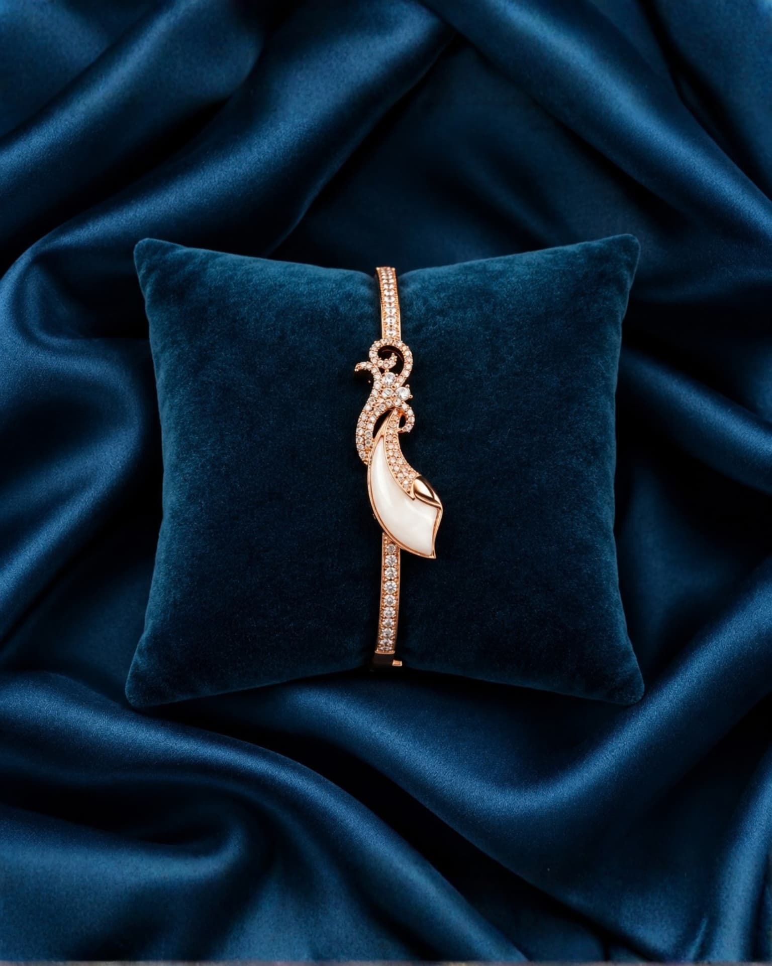 Full view of the white and diamond bracelet on a velvet cushion