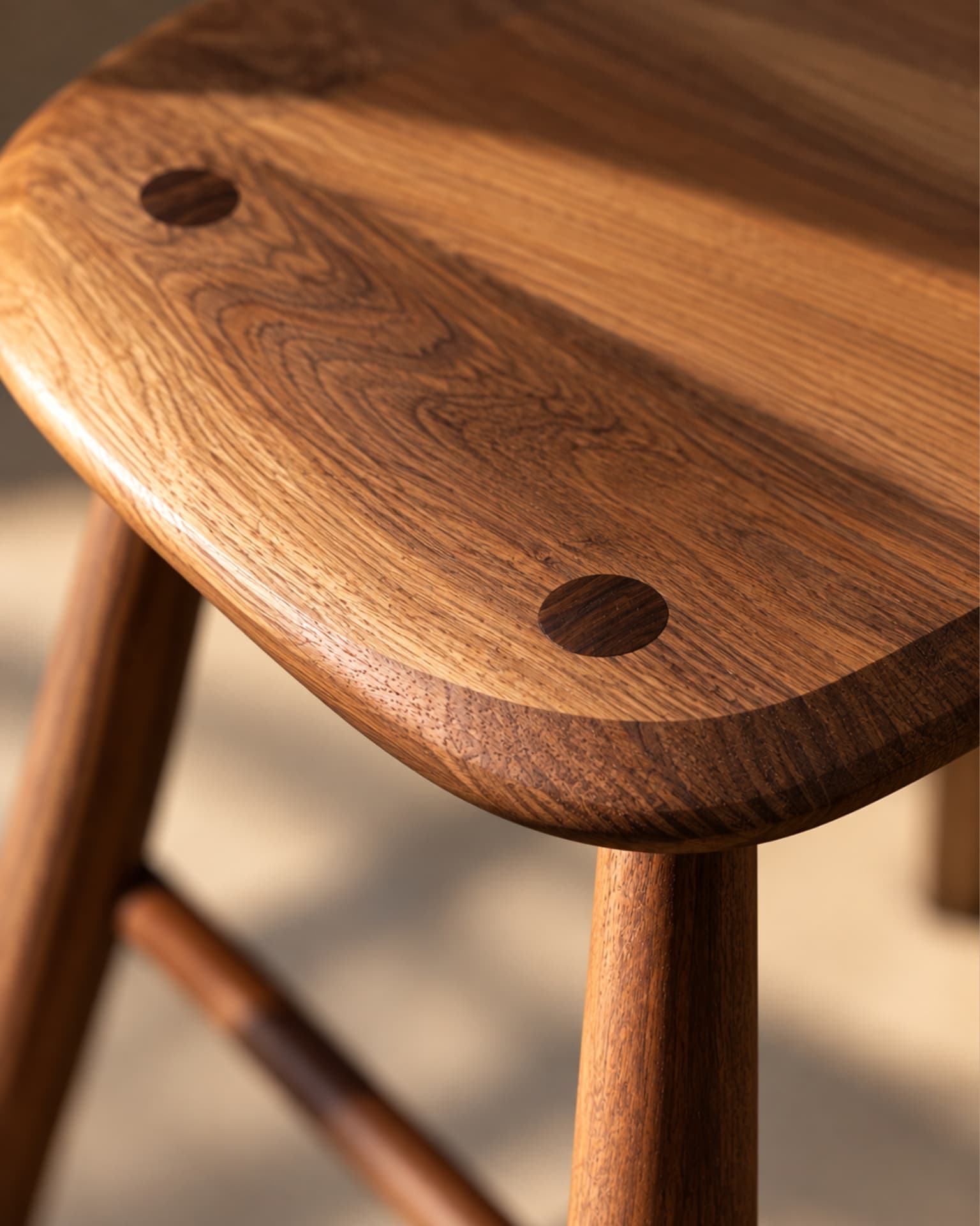 Macro photograph of the walnut stool seat and joinery